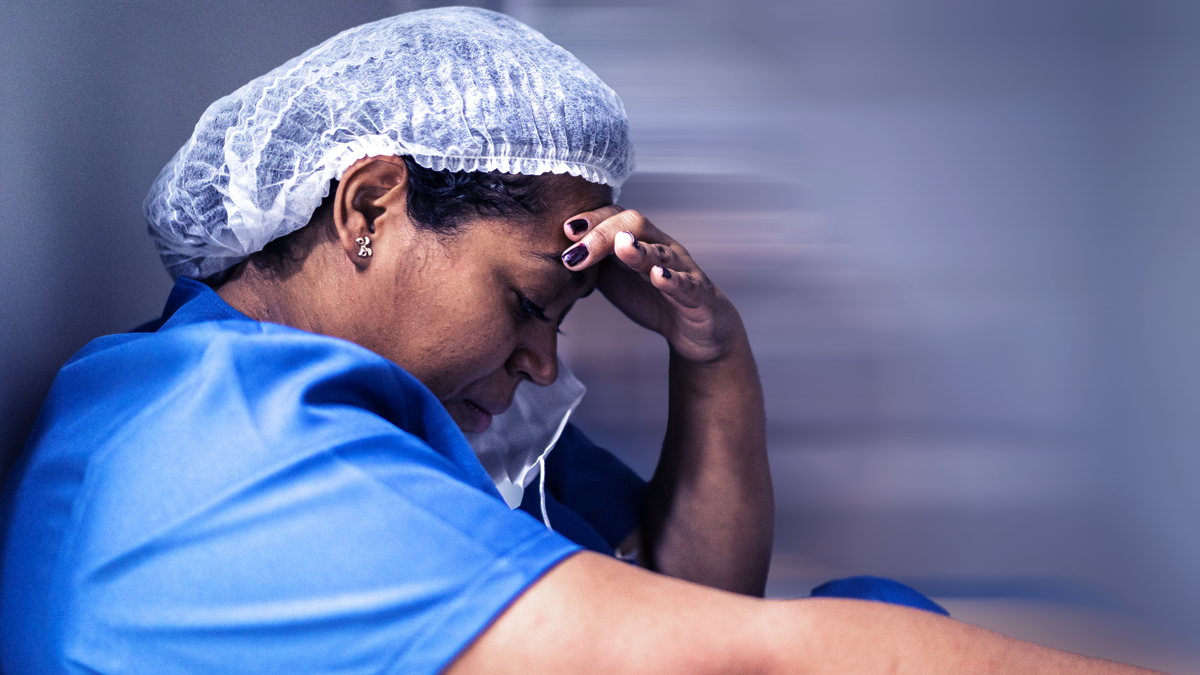 Decorative banner; Dark skin tone Health Care worker holding their head.